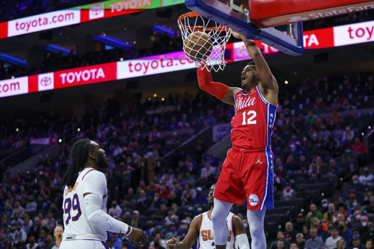 Philadelphia 76ers' Tobias Harris (R) dunks the ball as Phoenix Suns' Jae Crowder (L) looks on during the first half of an NBA basketball game in Philadelphia, on Feb. 8, 2022. (Chris Szagola/AP Photo)