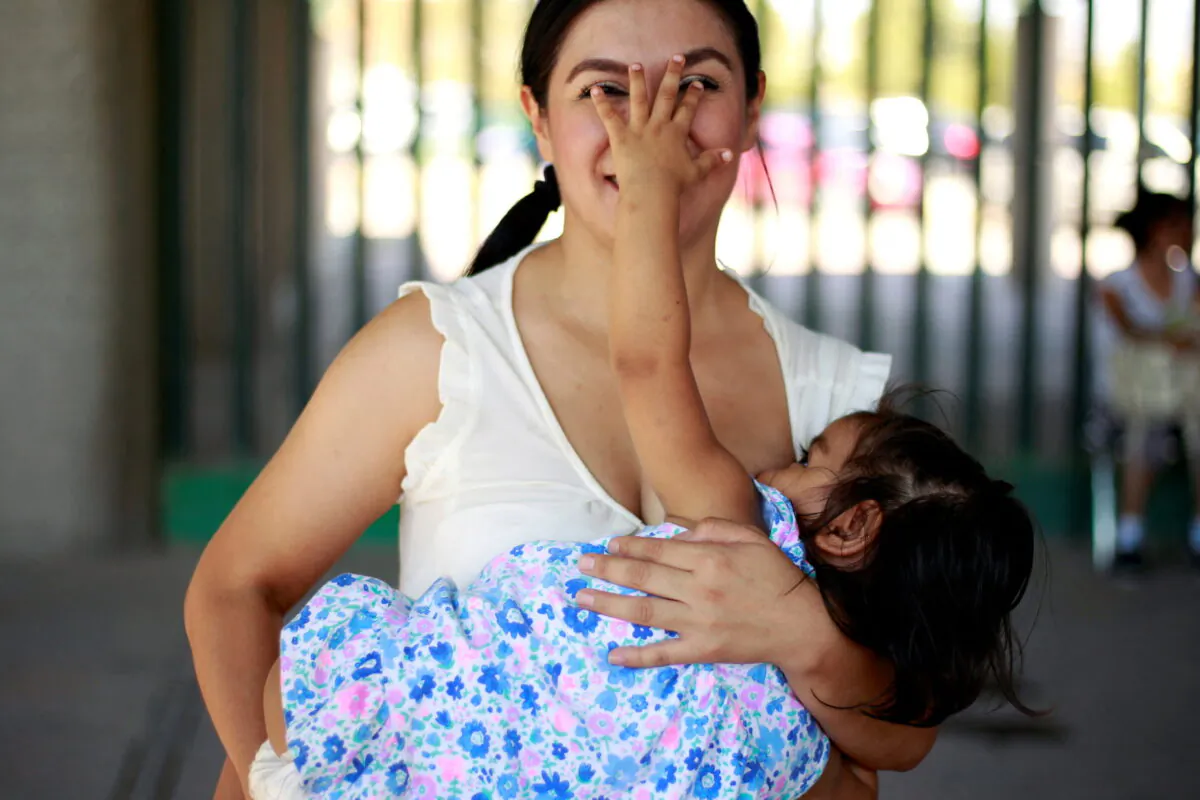 A mother reacts as she nurses her child to mark World Breastfeeding Week to promote global support for breastfeeding in Ciudad Juarez, Mexico, on Aug. 4, 2018. (Jose Luis Gonzalez/Reuters)