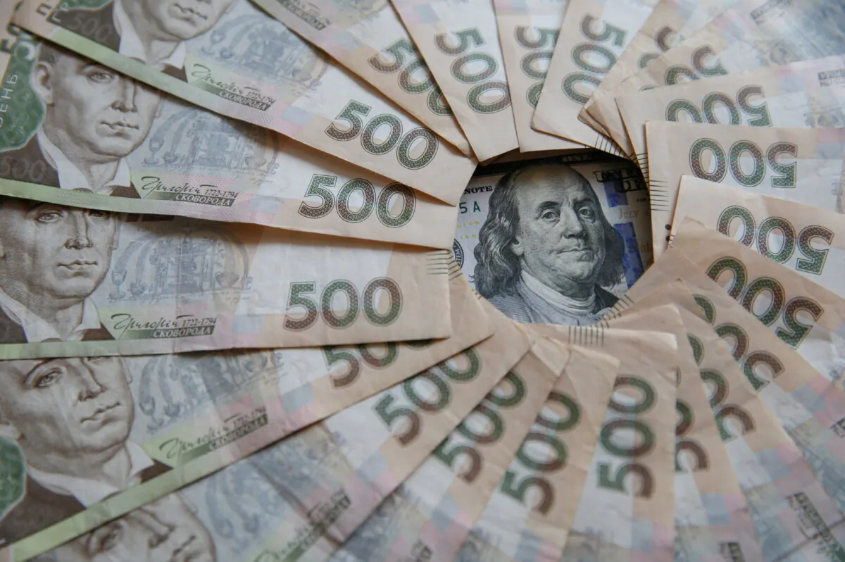 A Ukrainian 500 hryvnia banknotes and a U.S. 100 dollar banknote are seen in this picture illustration taken in Kyiv, Ukraine, on Oct. 31, 2016. (Valentyn Ogirenko/Illustration/Reuters)
