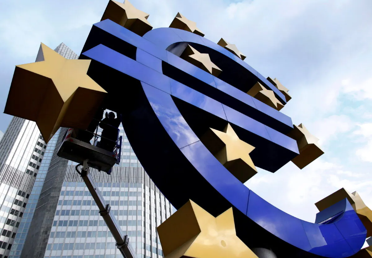 Workers maintain the huge Euro logo in front of the headquarters of the European Central Bank (ECB) in Frankfurt, Dec. 6, 2011. (Ralph Orlowski/Reuters)