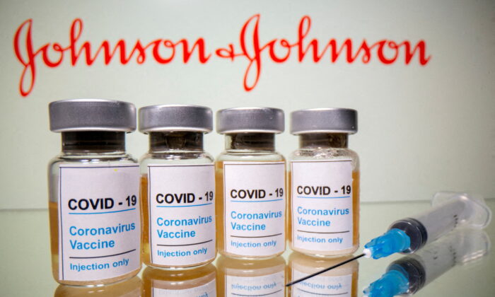 Vials with a sticker reading, "COVID-19/Coronavirus vaccine/Injection only" and a medical syringe are seen in front of a displayed Johnson & Johnson logo in this illustration taken on Oct. 31, 2020. (Dado Ruvic/Reuters)