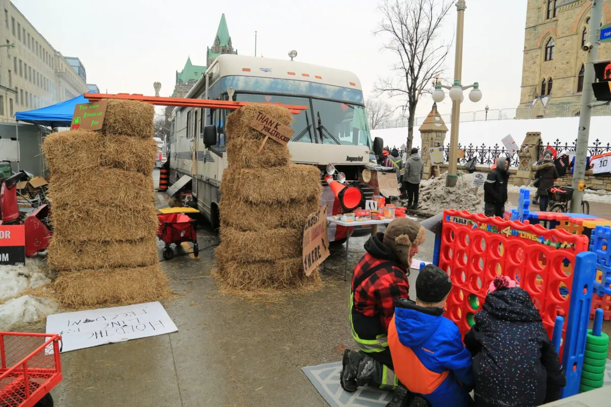Children play at an improvised play area at the protest site where demonstrators have camped to protest against COVID-19 mandates and restrictions, in Ottawa on Feb. 9, 2022. (Jonathan Ren/The Epoch Times)