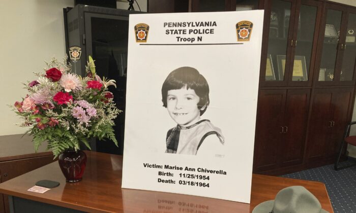 A poster of Marise Ann Chiverella is displayed with a vase of flowers and a trooper's hat at a Pennsylvania State Police news conference in Hazleton, Pa., on Feb. 10, 2022. (Michael Rubinkam/AP Photo)
