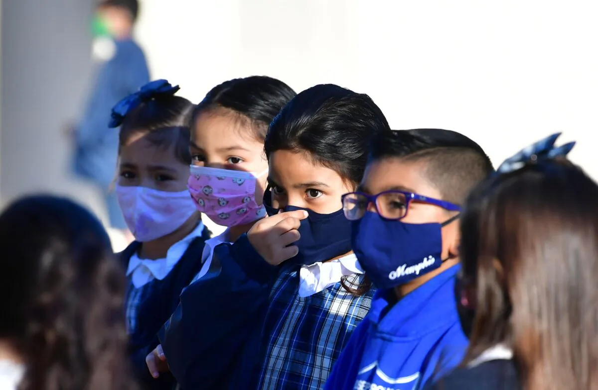 A student adjusts her facemask at St. Joseph Catholic School in La Puente, Calif., on Nov. 16, 2020. (Frederic J. Brown/AFP via Getty Images)