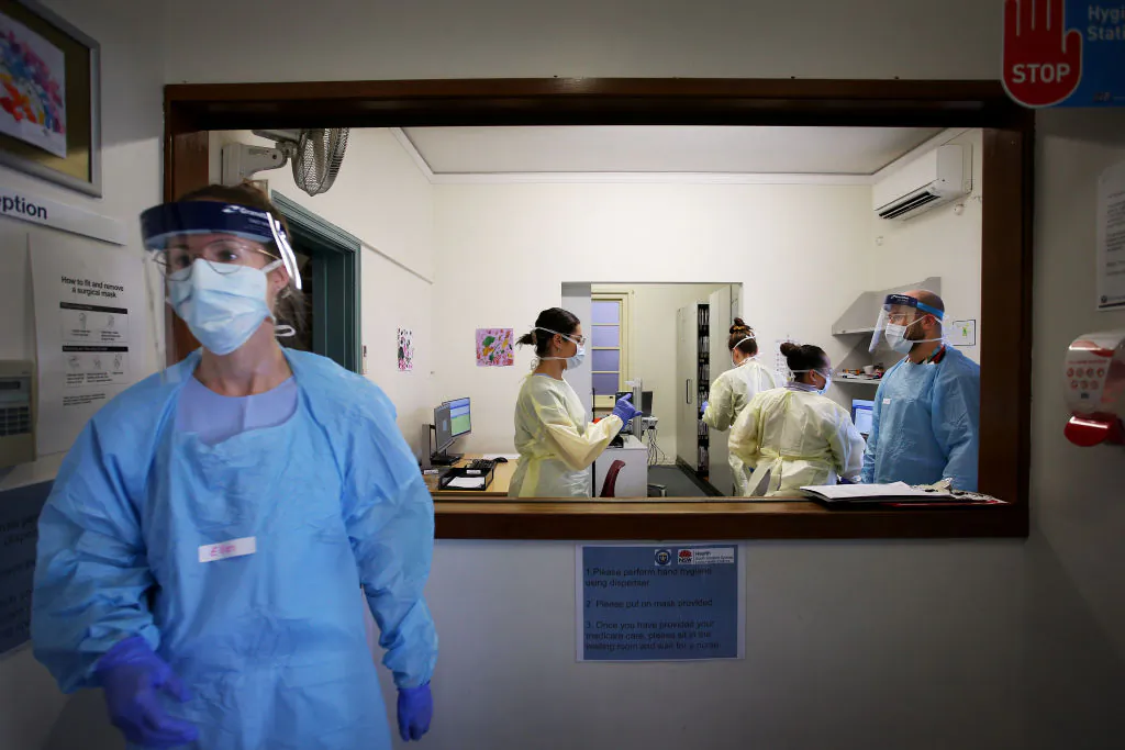 A nurse goes to assist a patient at the COVID-19 and flu assessment clinic at Prince of Wales Hospital in Sydney, Australia, on May 12, 2020. (Lisa Maree Williams/Getty Images)