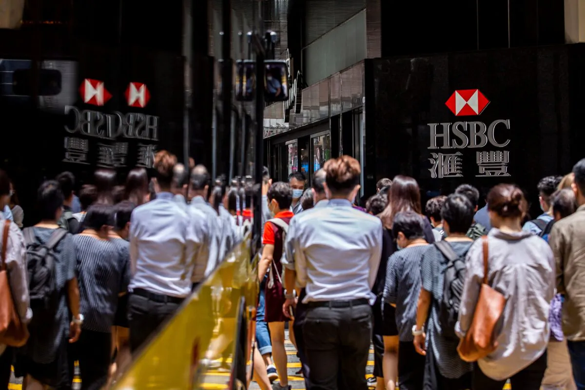 Pedestrians walk past the logo for HSBC outside a local branch bank in Hong Kong on Aug. 2, 2021. (Isaac Lawrence/AFP via Getty Images)