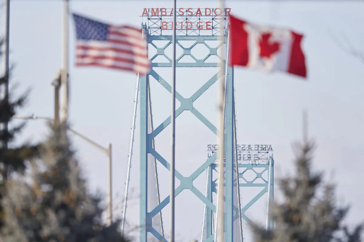 The American and Canadian flags fly at the Ambassador Bridge border crossing in Windsor, Ont., Canada, on Feb. 9, 2022. (Geoff Robins/AFP via Getty Images)