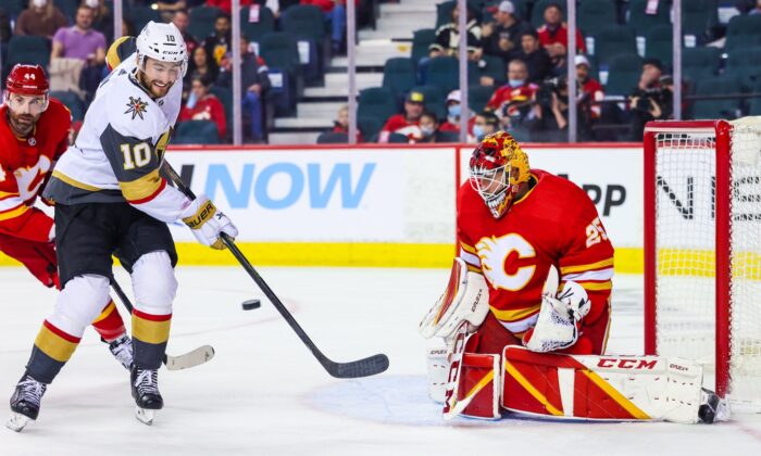Calgary Flames goaltender Jacob Markstrom (25) makes a save as Vegas Golden Knights center Nicolas Roy (10) tries to score during the second period at Scotiabank Saddledome, in Calgary, Alberta, Canada, on Feb. 9, 2022. (Sergei Belski/USA TODAY Sports via Field Level Media)