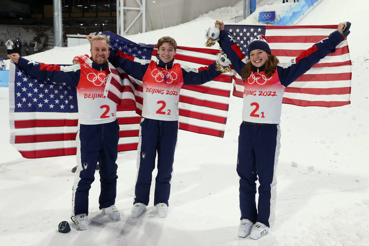 Team USA gold medallists, Justin Schoenefeld, Christopher Lillis, and Ashley Caldwell, pose during the Freestyle Skiing Mixed Team Aerials flower ceremony on Day 6 of the Beijing 2022 Winter Olympics at Genting Snow Park in Zhangjiakou, China, on Feb. 10, 2022. (Ezra Shaw/Getty Images)
