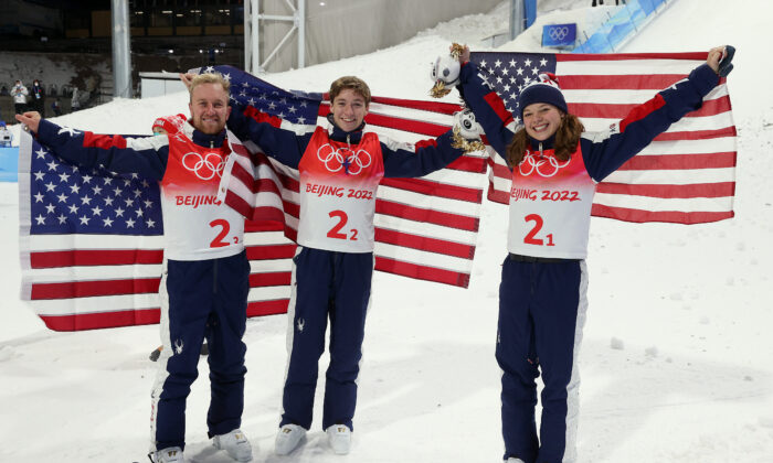 Team USA gold medallists, Justin Schoenefeld, Christopher Lillis, and Ashley Caldwell, pose during the Freestyle Skiing Mixed Team Aerials flower ceremony on Day 6 of the Beijing 2022 Winter Olympics at Genting Snow Park in Zhangjiakou, China, on Feb. 10, 2022. (Ezra Shaw/Getty Images)