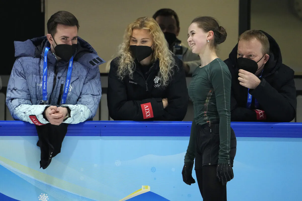 Kamila Valieva of the Russian Olympic Committee talks to coaches at a training session at the 2022 Winter Olympics in Beijing on Feb. 10, 2022. (Jeff Roberson/AP Photo)