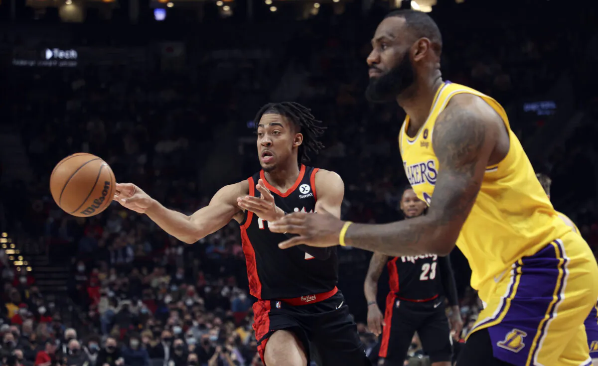 Portland Trail Blazers forward Trendon Watford, left, passes the ball as Los Angeles Lakers forward LeBron James, right, defends during the first half of an NBA basketball game in Portland, Ore. on Feb. 9, 2022. (Steve Dipaola/AP Photo)