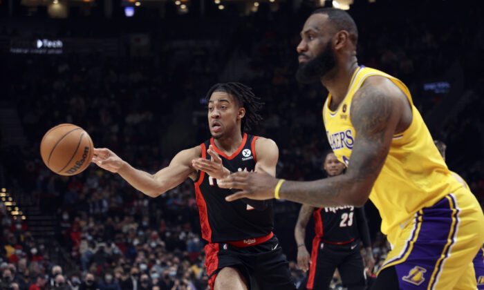 Portland Trail Blazers forward Trendon Watford, left, passes the ball as Los Angeles Lakers forward LeBron James, right, defends during the first half of an NBA basketball game in Portland, Ore. on Feb. 9, 2022. (Steve Dipaola/AP Photo)