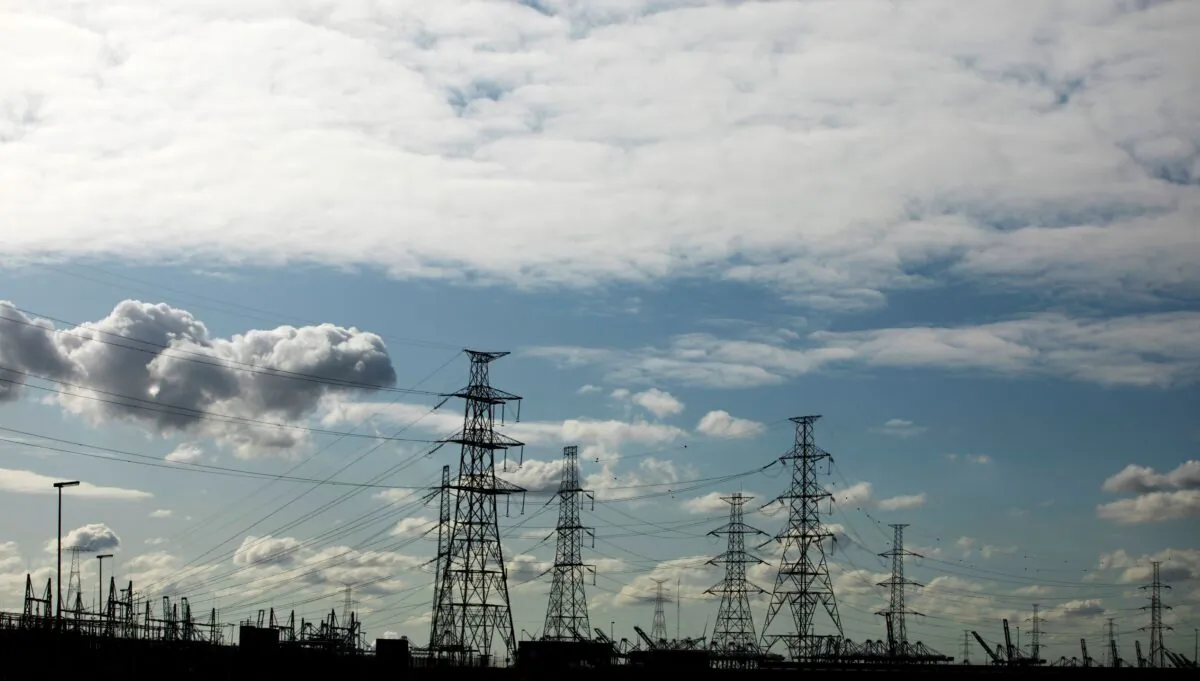 High tension wires and port cranes are silhouetted in the town of Doel, Belgium, on Sept. 19, 2019. (Virginia Mayo/AP Photo)