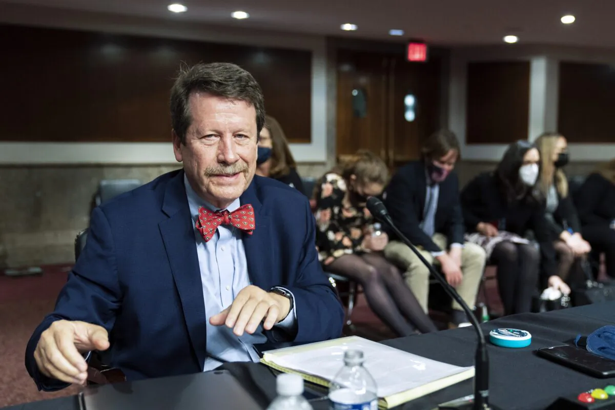 Dr. Robert Califf gathers his documents as the Senate Committee on Health, Education, Labor and Pension adjourn a hearing on the nomination of Califf to be commissioner of Food and Drug Administration on Capitol Hill in Washington, on Dec. 14, 2021. (Manuel Balce Ceneta/AP Photo)