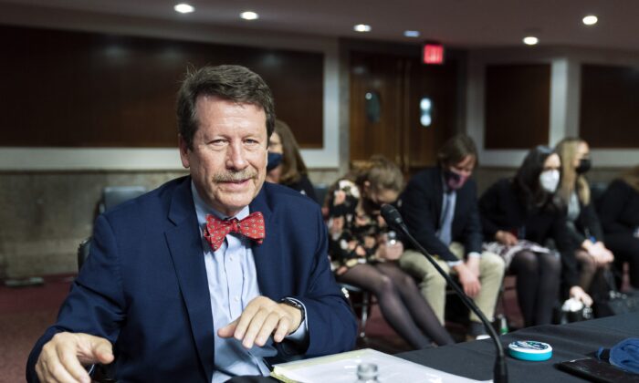 Dr. Robert Califf gathers his documents as the Senate Committee on Health, Education, Labor and Pension adjourn a hearing on the nomination of Califf to be commissioner of Food and Drug Administration on Capitol Hill in Washington, on Dec. 14, 2021. (Manuel Balce Ceneta/AP Photo)
