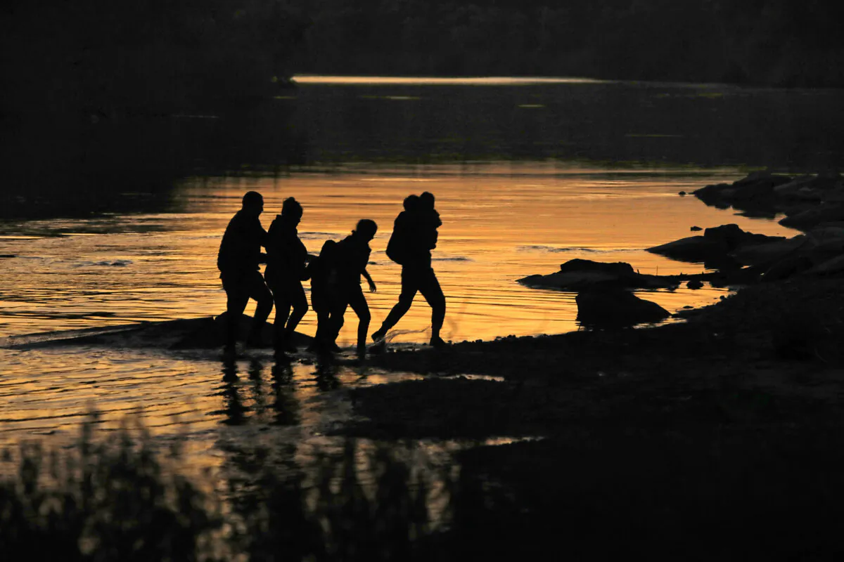 A surge in asylum seekers crossing the border in the Rio Grande Valley has put a strain on the immigration system. Here, migrants are on the move, in Mission, Texas, on March 17, 2021. (Los Angeles Times via TCA)