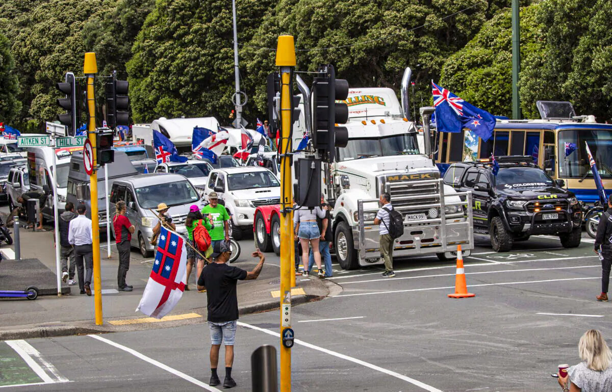 A convoy of vehicles block an intersection near New Zealand's Parliament in Wellington Tuesday, Feb. 8, 2022. Hundreds of people protesting vaccine and mask mandates drove in convoy to New Zealand's capital on Tuesday and converged outside Parliament as lawmakers reconvened after a summer break. (Mark Mitchell/New Zealand Herald via AP)