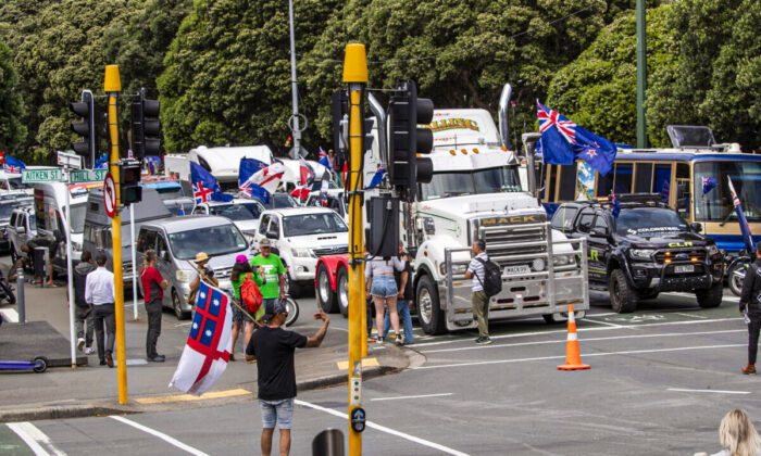 A convoy of vehicles block an intersection near New Zealand's Parliament in Wellington Tuesday, Feb. 8, 2022. Hundreds of people protesting vaccine and mask mandates drove in convoy to New Zealand's capital on Tuesday and converged outside Parliament as lawmakers reconvened after a summer break. (Mark Mitchell/New Zealand Herald via AP)