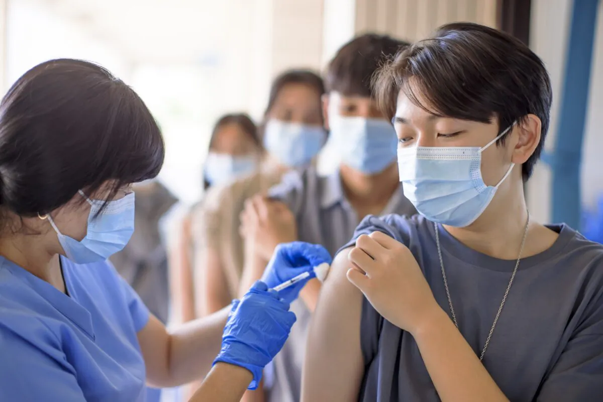 Doctor administer a vaccine. (Tom Wang/Adobe Stock)