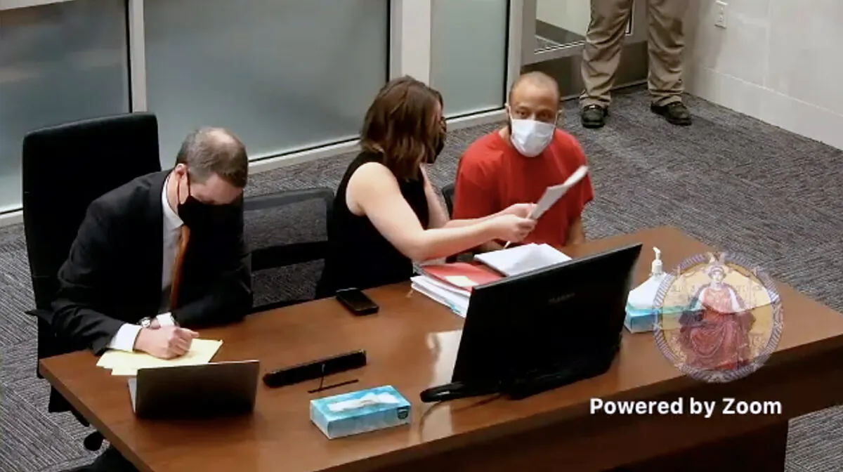 Darrell E. Brooks (R), who entered not-guilty pleas to 77 counts stemming from the Nov. 21 massacre at the Waukesha Christmas Parade, sits with his attorneys in Waukesha County Circuit Court on Feb. 11, 2022. (Waukesha County Circuit Court)