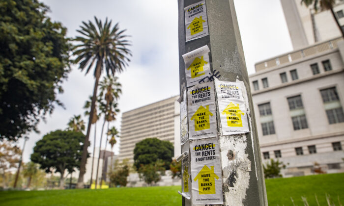 Stickers for rent cancelations are pasted to a light fixture in front of Los Angeles City Hall on Nov. 8, 2021. (John Fredricks/The Epoch Times)