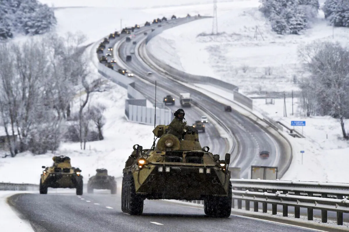 A convoy of Russian armored vehicles moves along a highway in Crimea on Jan. 18, 2022. (AP Photo)