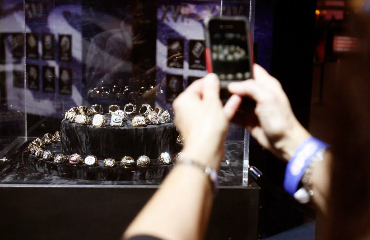 A fan takes a picture of a Super Bowl Ring display during the NFL Experience at the Ernest N. Morial Convention Center in New Orleans, on Jan. 31, 2013. (Mike Lawrie/Getty Images)