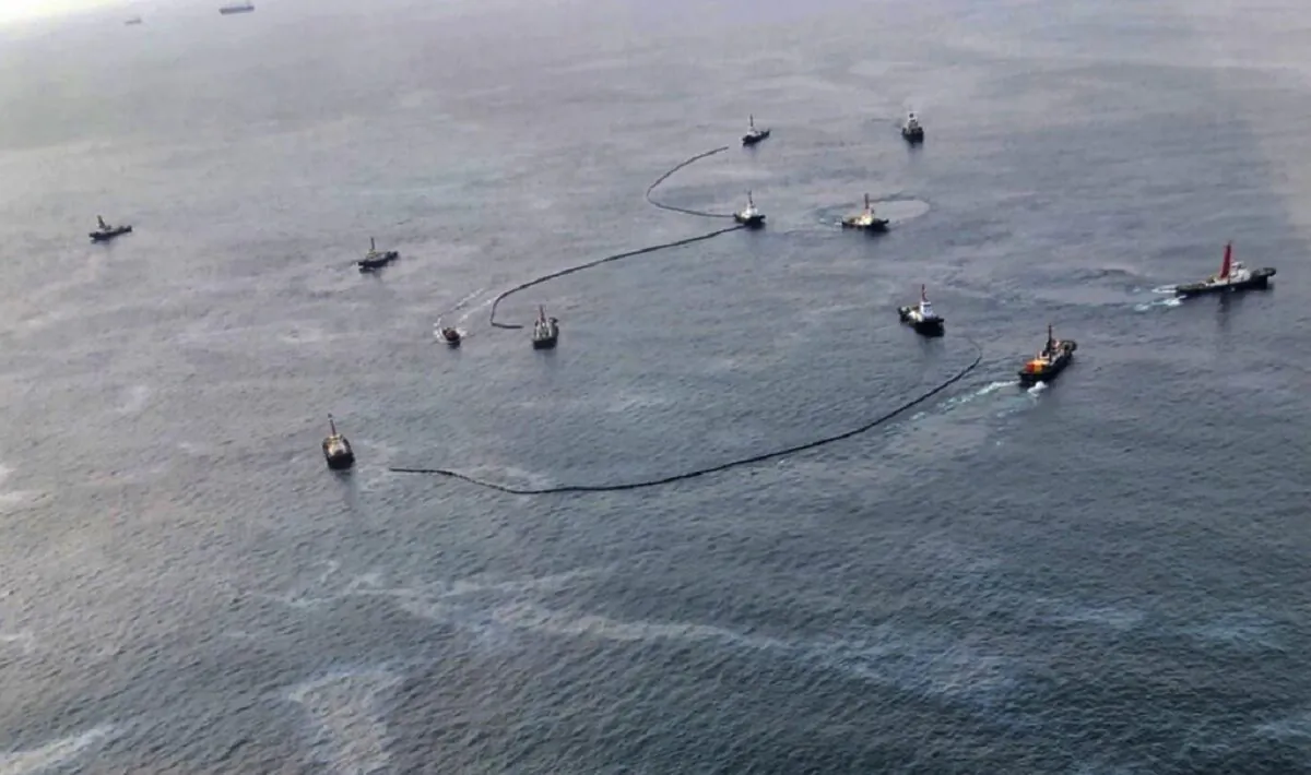 An aerial view shows cleanup efforts of the latest oil spill off the coast of Rayong, eastern Thailand, on Feb. 11, 2022. (Royal Thai Navy via AP)
