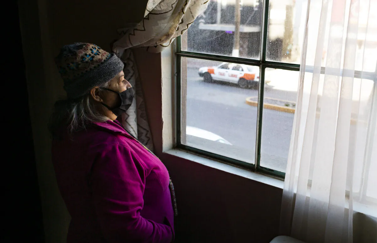 Ministry worker Rosario Acuña Hernañdez looks upon the streets of Zona Norte from the window of Iglesia Cristiana Bethel in Tijuana, Mex., on Feb. 5, 2022. (John Fredricks/The Epoch Times)
