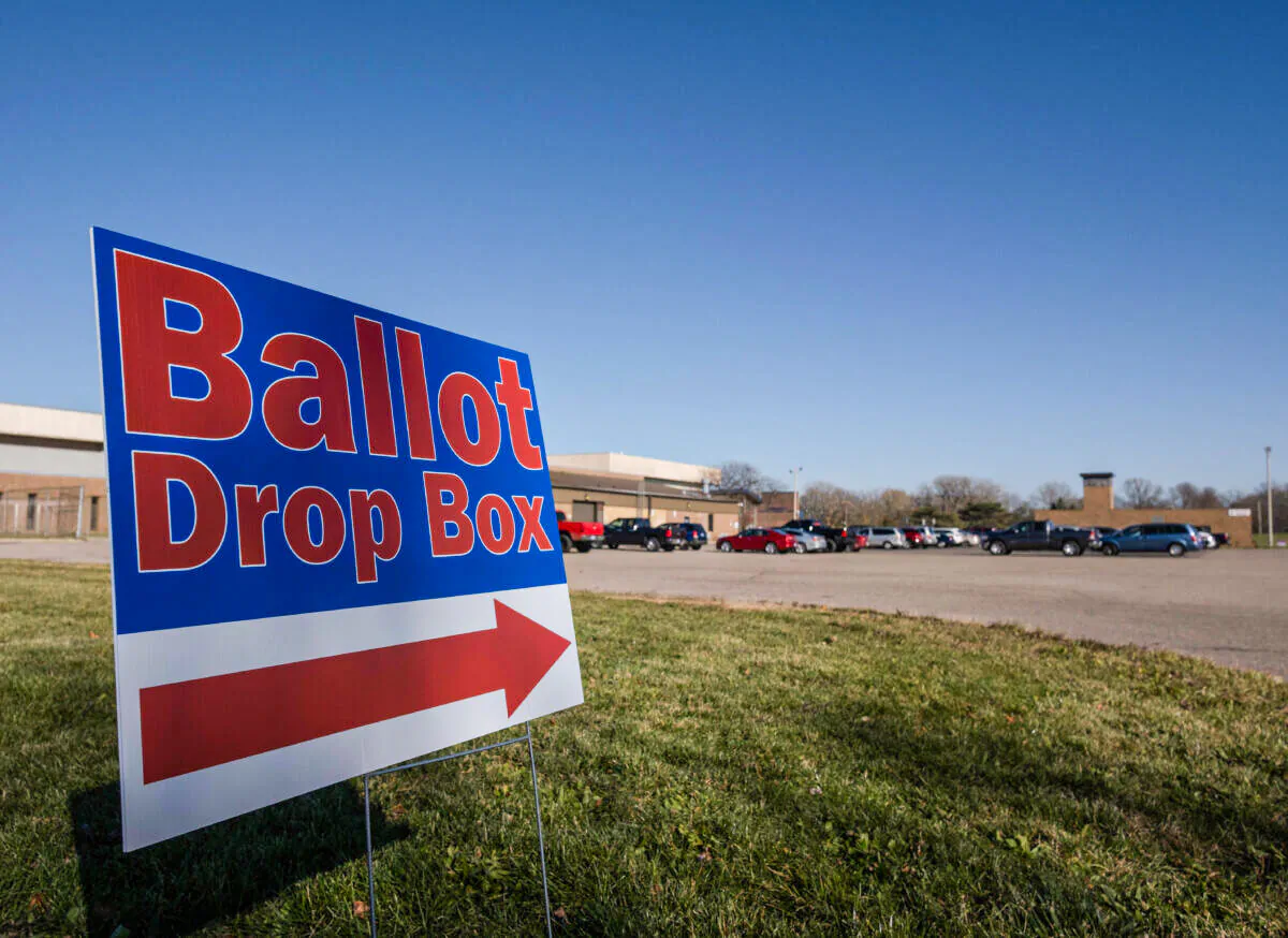 A sign pointing in the direction of a ballot drop box at the Schmidt Community Center polling station in Lansing, Mich., on Nov. 3,2020. (Seth Herald/AFP via Getty Images)