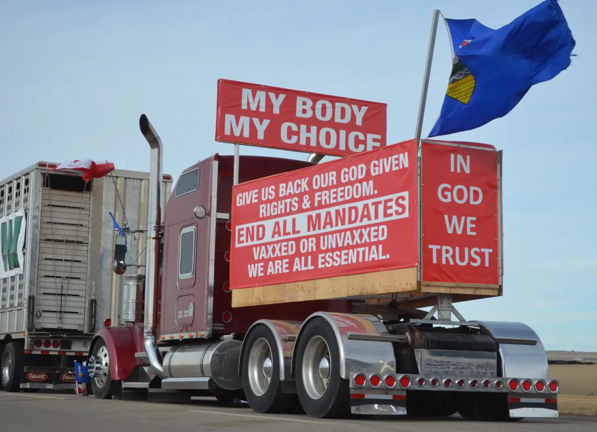 Vehicles parked by Coutts in southern Alberta, Canada, as part of a protest convoy blocking the Canada-U.S. border to demand the removal of COVID-19 mandates, on Feb. 10, 2022. (Michael Wing/The Epoch Times)
