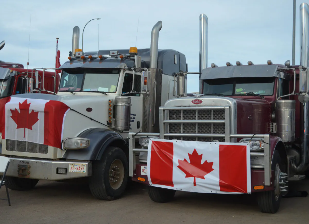 Vehicles parked by Coutts in southern Alberta, Canada, as part of a protest convoy blocking the Canada-U.S. border to demand the removal of COVID-19 mandates, on Feb. 10, 2022. (Michael Wing/The Epoch Times)