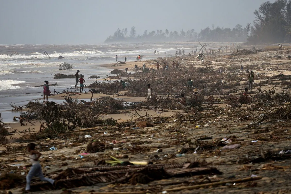 People search debris on the beach, in the aftermath of Cyclone Batsirai, in the town of Mananjary, Madagascar, on Feb. 8, 2022. (Alkis Konstantinidis/Reuters)