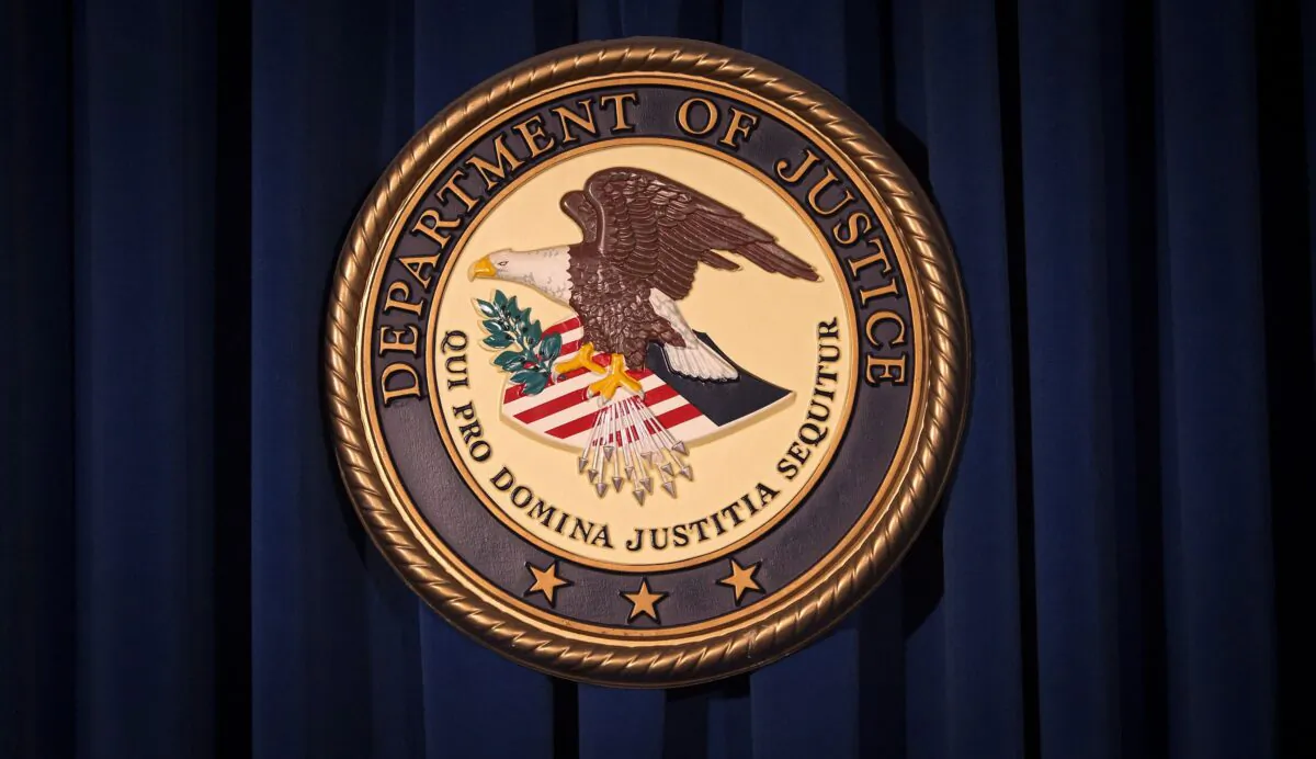 The Department of Justice (DOJ) logo is pictured on a wall after a news conference to discuss alleged fraud by Russian Diplomats in New York, on Dec. 5, 2013. (Carlo Allegri/file/Reuters)