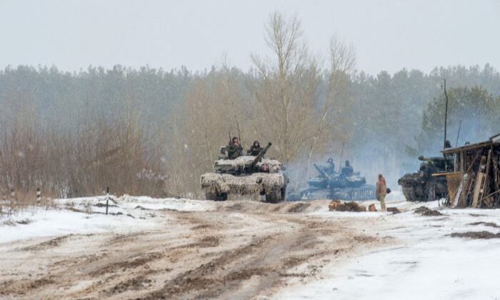 Ukrainian Military Forces servicemen of the 92nd mechanized brigade use tanks, self-propelled guns, and other armored vehicles to conduct live-fire exercises near the town of Chuguev, in the Kharkiv region, on Feb. 10, 2022. (Sergey Bobok/AFP via Getty Images)