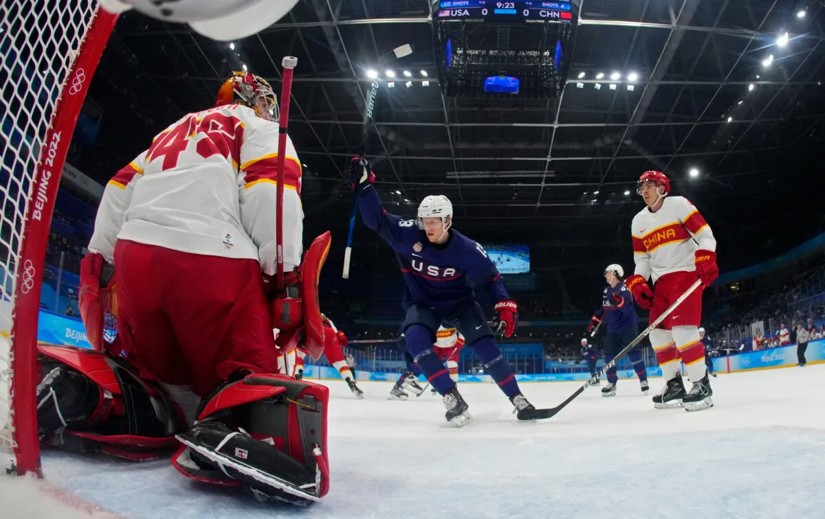 USA's Nathan Smith (C) celebrates after the team scored a goal on China's goaltender Jeremy Smith during the men's preliminary round group A match of the Beijing 2022 Winter Olympic Games ice hockey competition, at the National Indoor Stadium in Beijing on Feb. 10, 2022. (Matt Slocum/POOL/AFP via Getty Images)