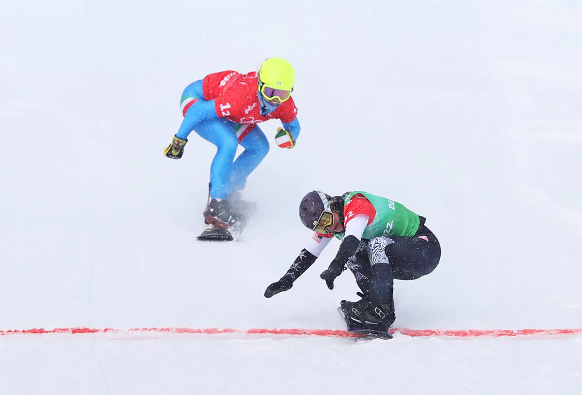 Lindsey Jacobellis of Team United States (R) and Michela Moioli of Team Italy (L) cross the finish line during the Snowboard Mixed Team Cross Big Final on Day 8 of the Beijing 2022 Winter Olympics at Genting Snow Park, in Zhangjiakou, China, on Feb. 12, 2022. (Cameron Spencer/Getty Images)