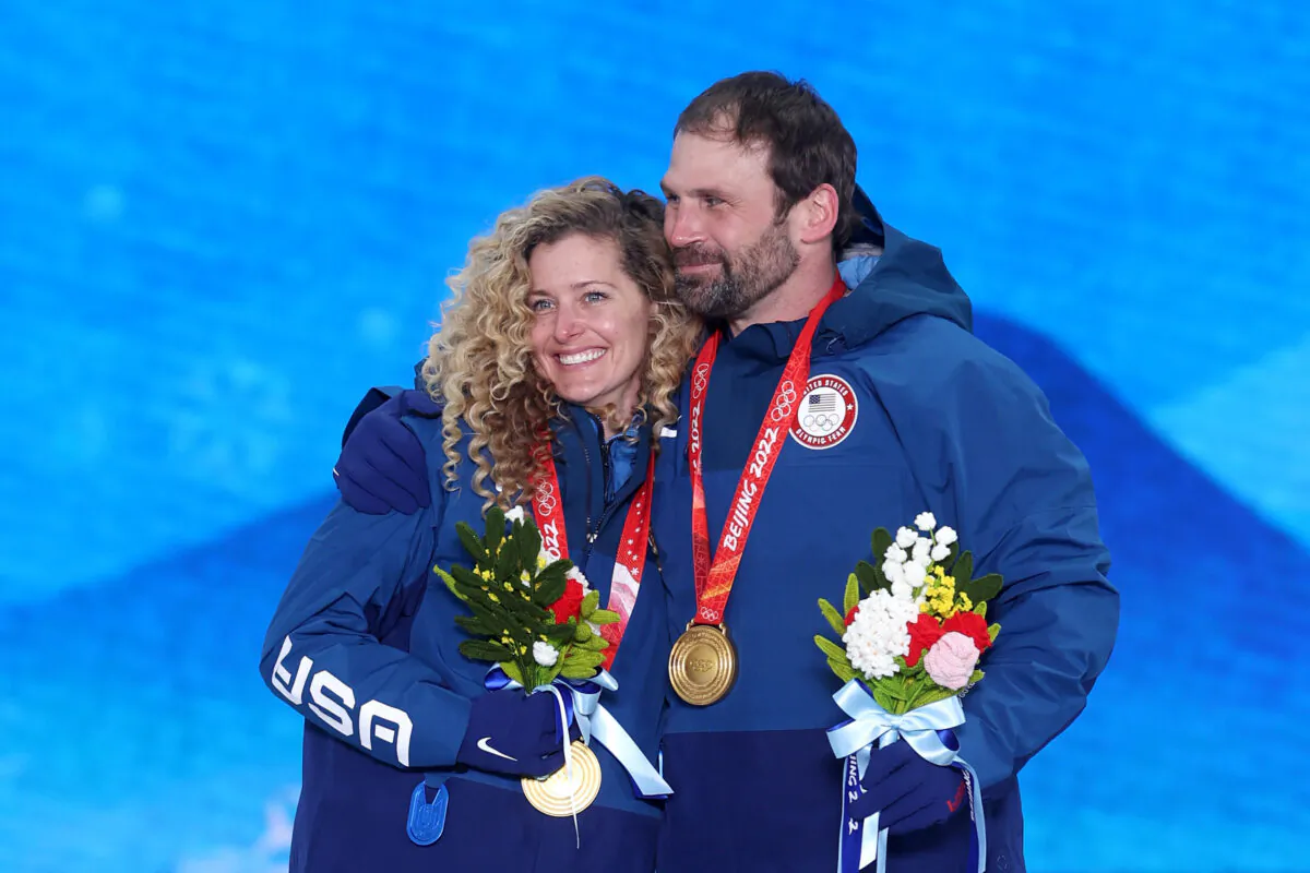 Gold medallists Lindsey Jacobellis and Nick Baumgartner of Team United States pose with their medals during the Mixed Team Snowboard Cross medal ceremony on Day 8 of the Beijing 2022 Winter Olympic Games at Zhangjiakou Medal Plaza, in Zhangjiakou, China, on Feb. 12, 2022. (Ezra Shaw/Getty Images)