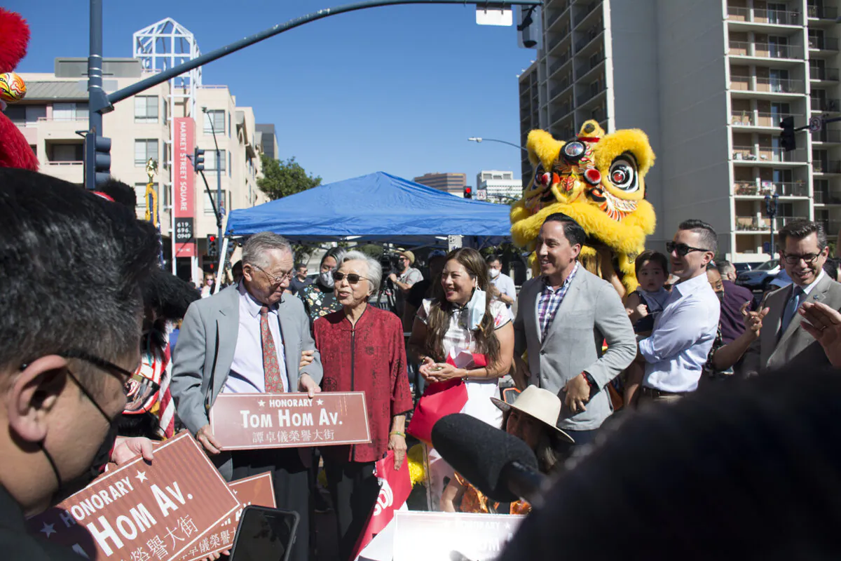 San Diego Asian American legend Tom Hom, 94, is honored with a block of Third Avenue dedicated to his name at a ceremony held in downtown San Diego on on Feb. 12, 2022. San Diego Mayor Todd Gloria, City Councilmen Chris Cate and Stephen Whitburn (4th to 6th from left) attend the ceremony. (Jane Yang/The Epoch Times)