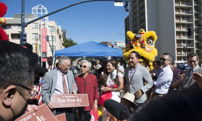 San Diego Asian American legend Tom Hom, 94, is honored with a block of Third Avenue dedicated to his name at a ceremony held in downtown San Diego on on Feb. 12, 2022. San Diego Mayor Todd Gloria, City Councilmen Chris Cate and Stephen Whitburn (4th to 6th from left) attend the ceremony. (Jane Yang/The Epoch Times)