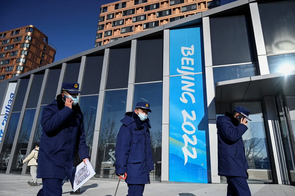 Security guards patrol the Beijing 2022 Winter Olympic Games village in Beijing on Dec. 24, 2021. (Jade Gao/AFP via Getty Images)