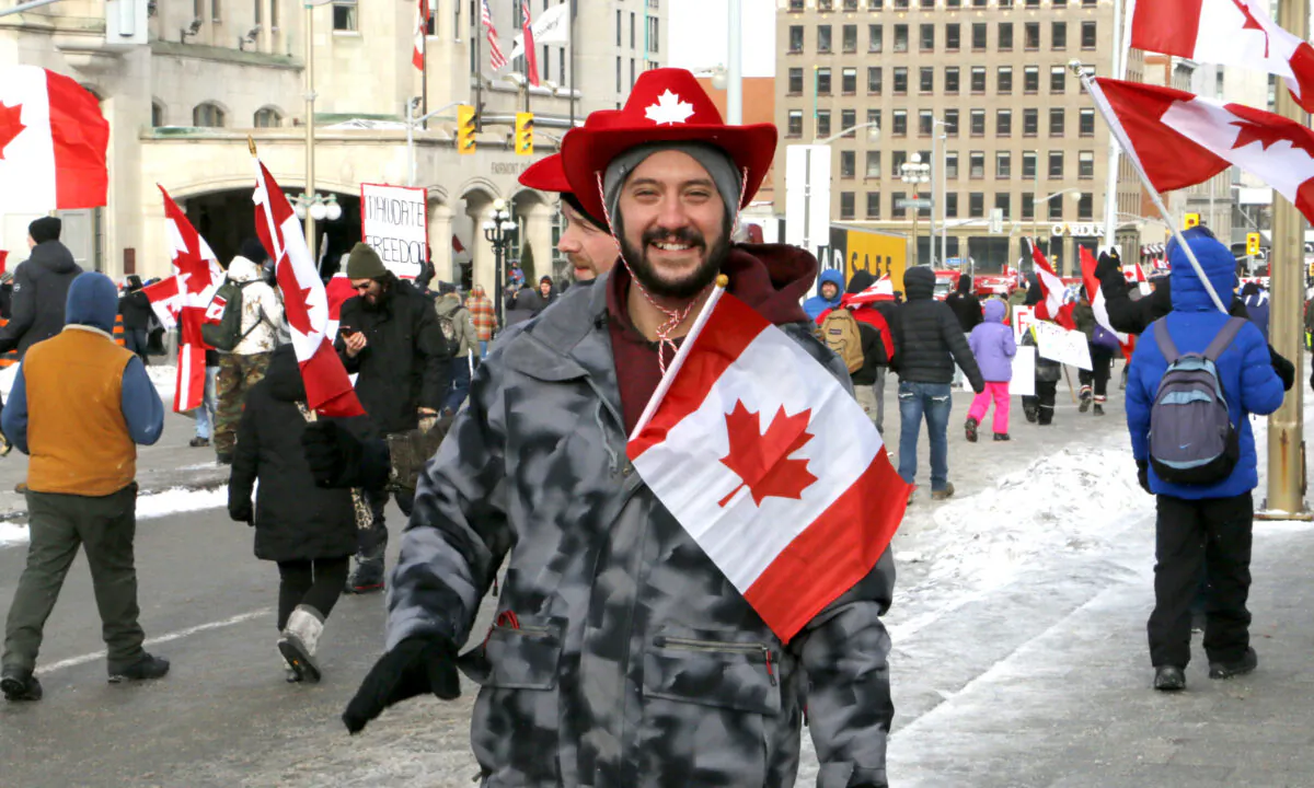 A protester walks on Wellington St. in Ottawa on 12 Feb., 2022. (Noé Chartier/The Epoch Times)