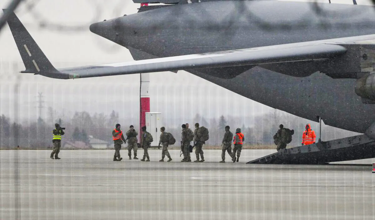 U.S. Army troops of the 82nd Airborne Division unloading vehicles from a transport plane after arriving from Fort Bragg, at the Rzeszow-Jasionka airport in southeastern Poland, on Feb. 6, 2022. (Czarek Sokolowski/AP Photo)