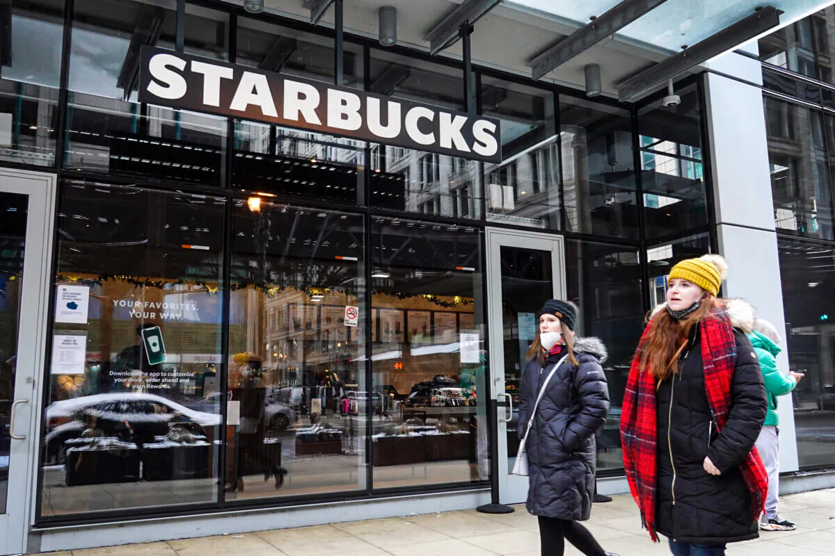 A Starbucks sign hangs above the entrance of one of the chain's coffee shops in the Loop in Chicago on Jan. 4, 2022. (Scott Olson/Getty Images)