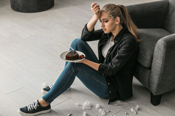 Lonely,Depressed,Woman,Eating,Chocolate,Cake,At,Home