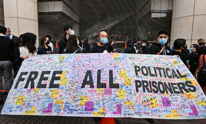 A crowd gathers outside the West Kowloon Magistrates' Courts, where 47 dissidents, charged under the Beijing-imposed national security law, were about to appear in court, in Hong Kong on Mar. 1, 2021. (Adrian Yu/The Epoch Times)