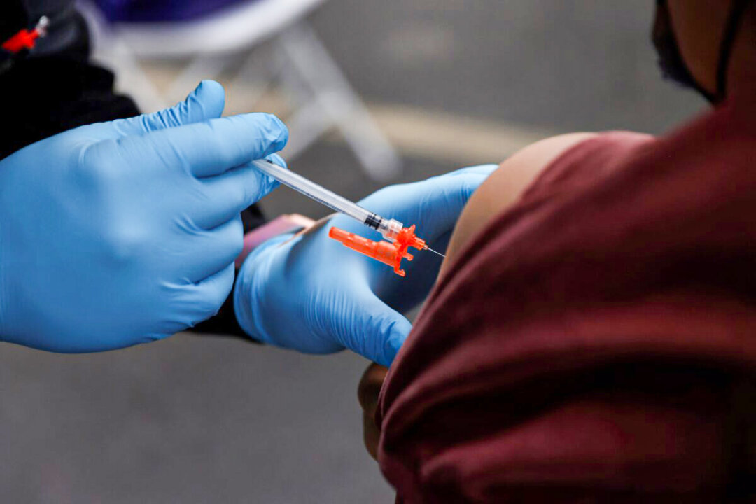 A COVID-19 vaccine is administered to a person in Los Angeles on Jan. 29, 2022. (Shannon Stapleton/Reuters)