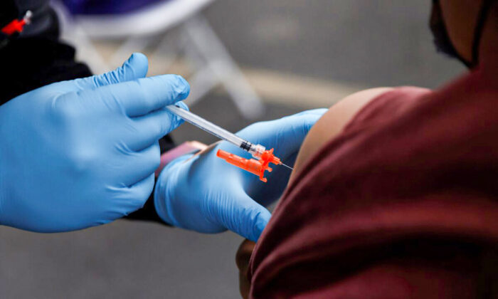 A Pfizer-BioNTech COVID-19 vaccine is administered to a person in Los Angeles, Calif., on Jan. 29, 2022. (Shannon Stapleton/Reuters)