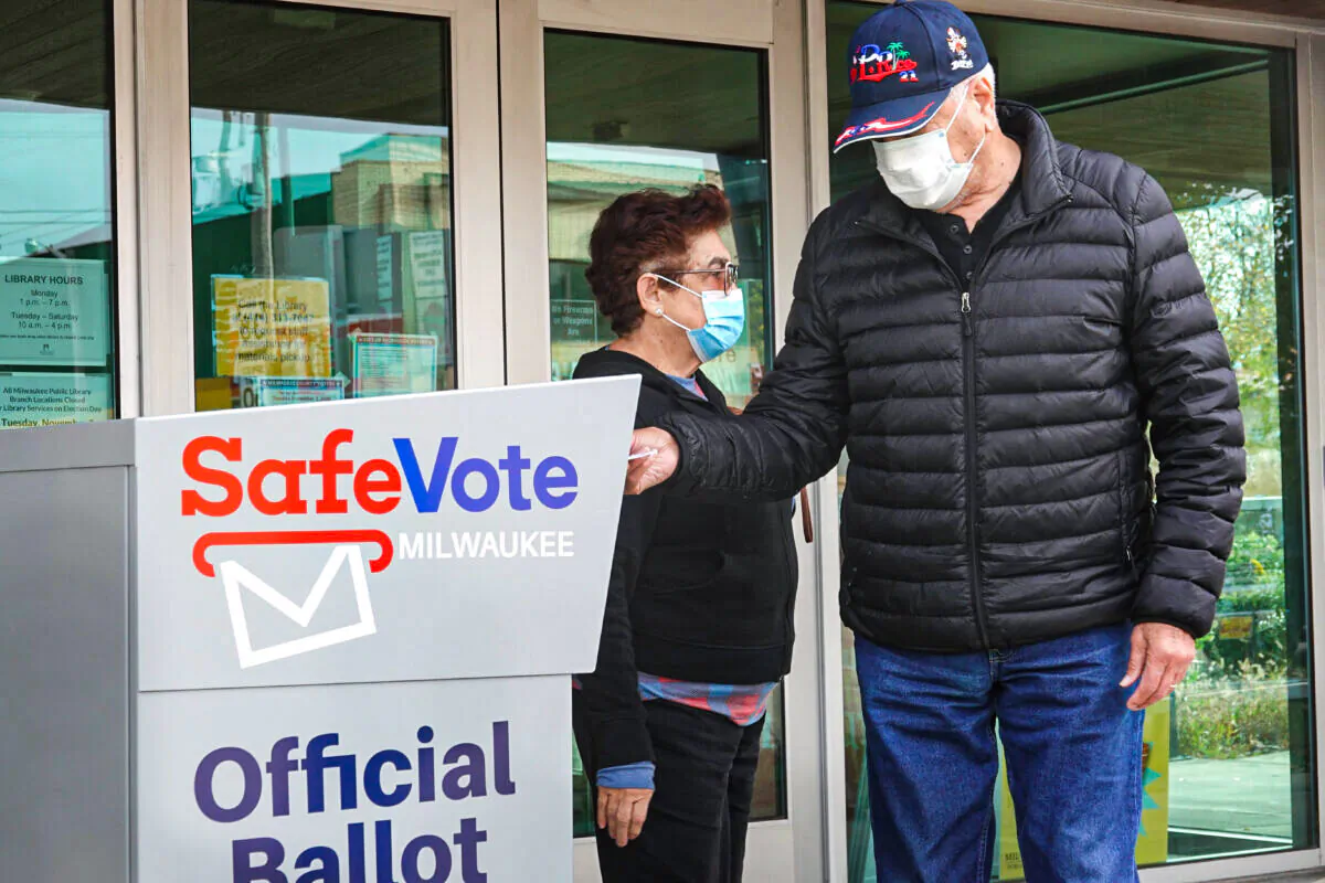 Residents drop mail-in ballots in a ballot box outside of the Tippecanoe branch library in Milwaukee on Oct. 20, 2020. (Scott Olson/Getty Images)